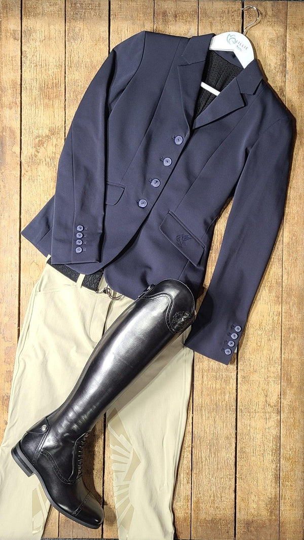 A rider's ensemble: a show coat, breeches, and tall boots. All ready for the show ring.