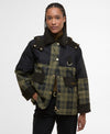 Person wearing a black and plaid jacket on a white background