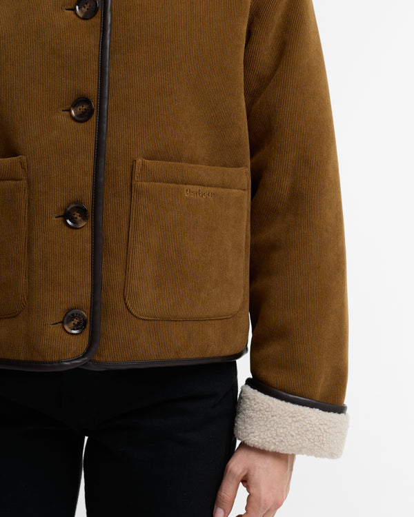 Brown corduroy jacket with button details on a white background