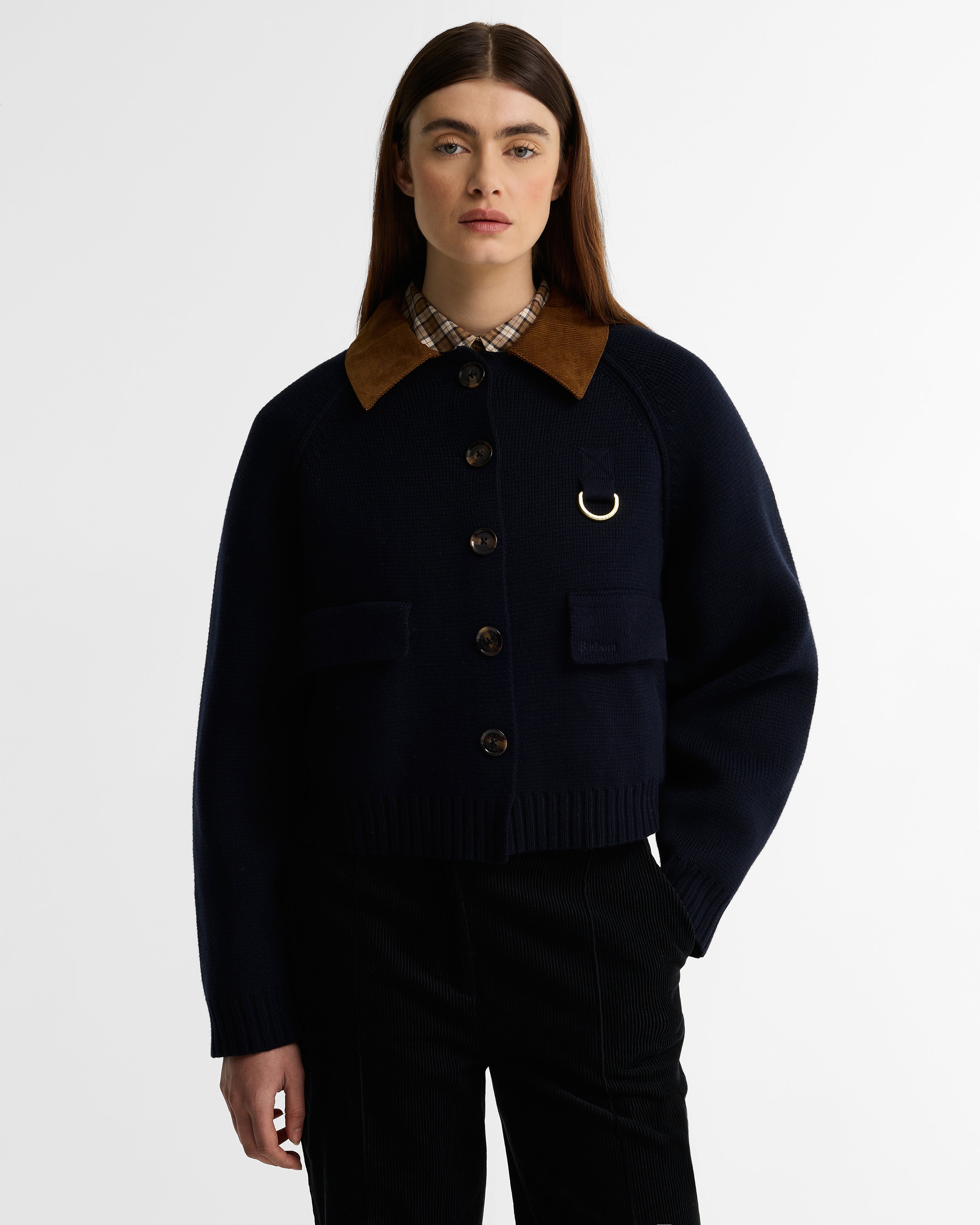 Person wearing a dark blue jacket with a brown collar on a white background