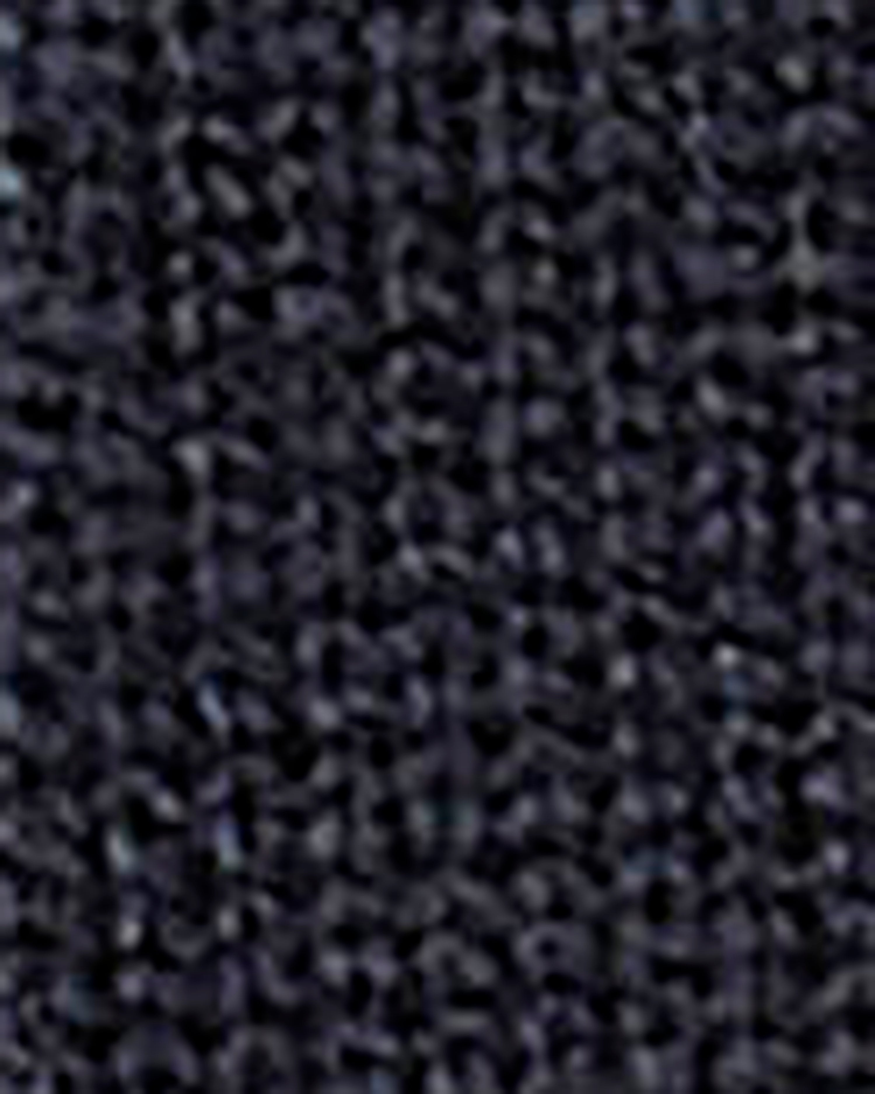 A close-up texture shot of a dark, heavily textured material with a mottled pattern of black, dark gray, and subtle purple undertones.