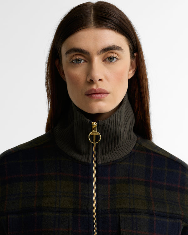 Close-up of the Barbour Ivybridge Overshirt showing the ribbed stand collar, gold ring zipper pull, and shadow tartan wool fabric.