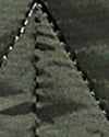 A close-up, low-resolution view of a textured gray surface with a triangular pattern and a dashed white line along the left edge.