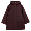 A dark burgundy hooded raincoat with gold-tone metal hardware, including snap buttons and a D-ring, displayed on a clean white background. The Barbour brand name is visible on the front pocket.