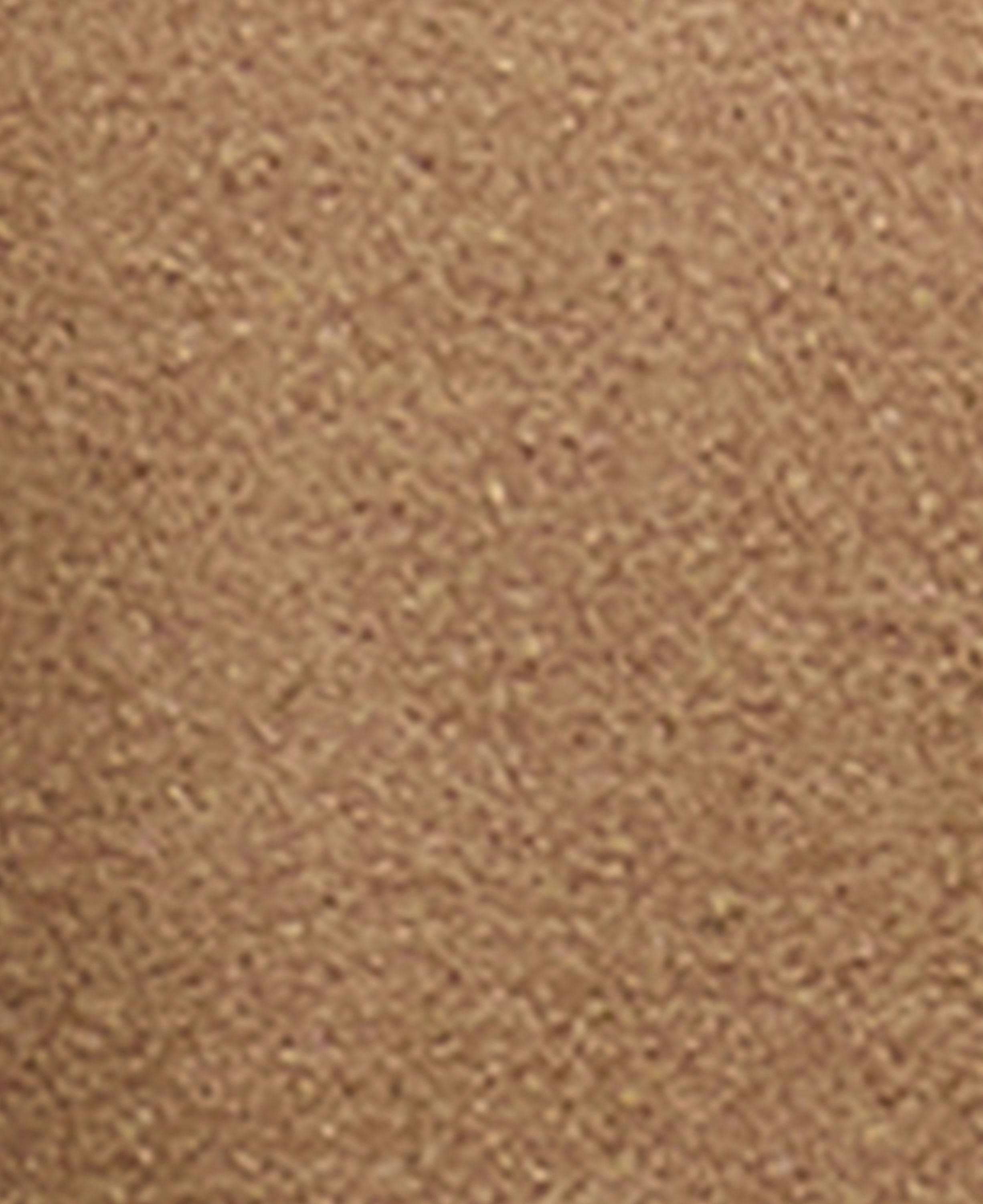 A close-up texture shot of a warm tan or light brown material, showing a fine, granular surface.