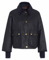 A black waxed canvas jacket with a black corduroy collar, gold-tone snap buttons, and front flap pockets, shown on a plain white background.