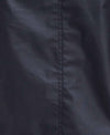 Close-up of a black fabric surface with a vertical seam running down the center.