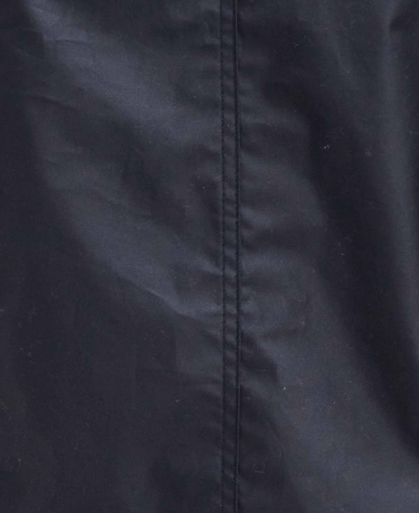 Close-up of a black fabric surface with a vertical seam running down the center.