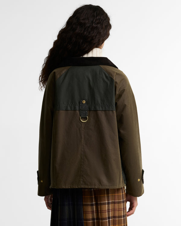 Rear view of the Barbour Hazelwood Wax Jacket showing the two-tone olive and slate waxed cotton back panel, gold D-ring at the center back yoke seam, corduroy collar, and corduroy cuff tabs with gold snap buttons.