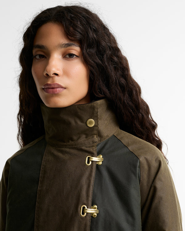 Close-up of the Barbour Hazelwood Wax Jacket showing the funnel neck storm collar with gold snap button and the top gold equestrian hook-and-eye closure.