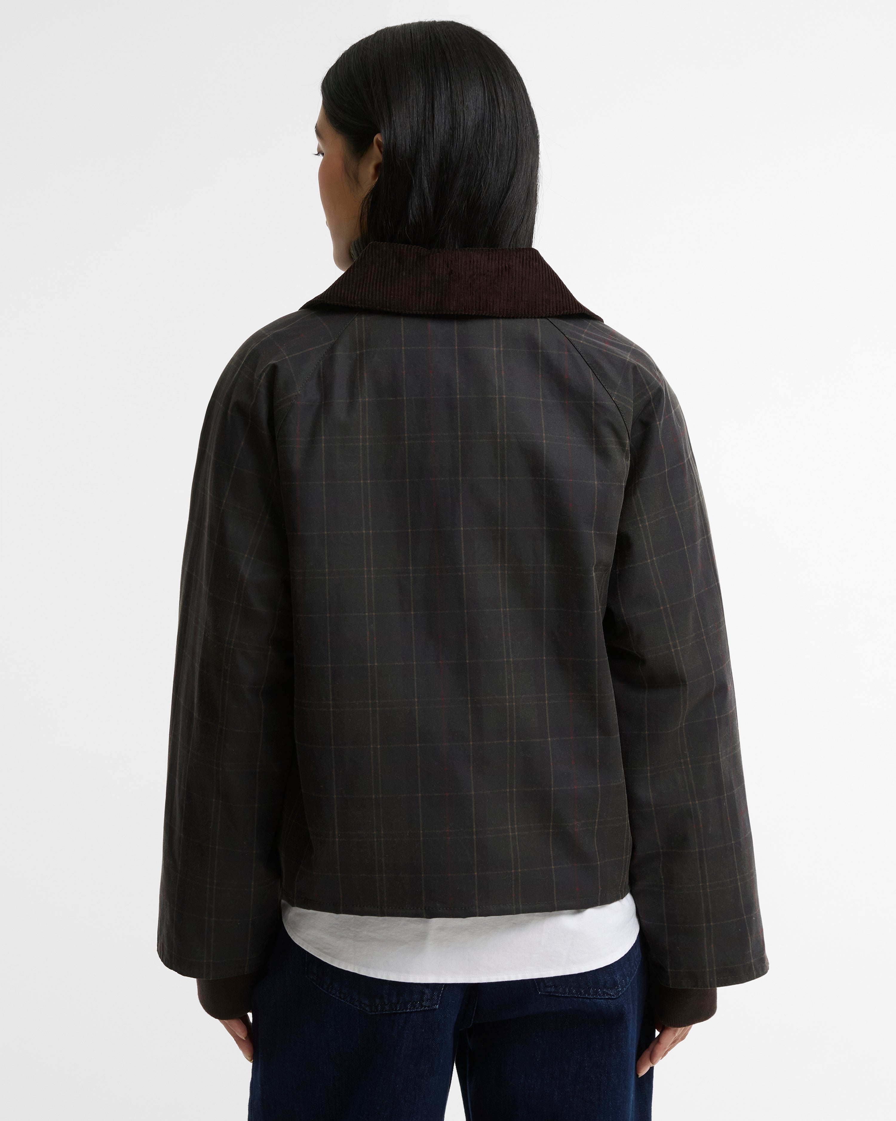 A person shown from the back wearing a dark charcoal plaid jacket with a contrasting dark brown collar, over a white shirt and dark blue jeans, against a plain white studio background.
