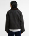 A person shown from the back wearing a dark charcoal plaid jacket with a contrasting dark brown collar, over a white shirt and dark blue jeans, against a plain white studio background.