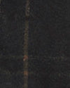 A close-up texture shot of a dark waxed cotton fabric.
