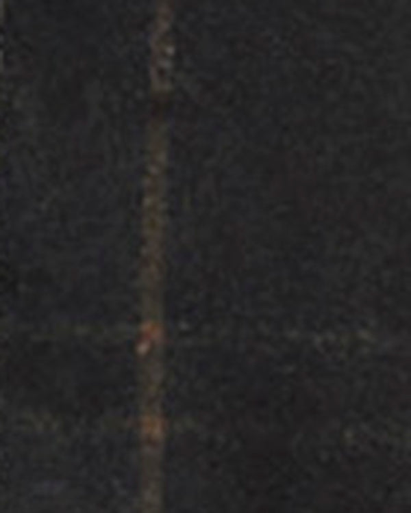 A close-up texture shot of a dark waxed cotton fabric.