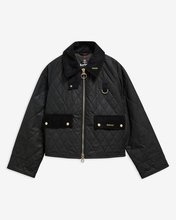 Black quilted wax jacket with gold zippers and buttons on a light gray background.