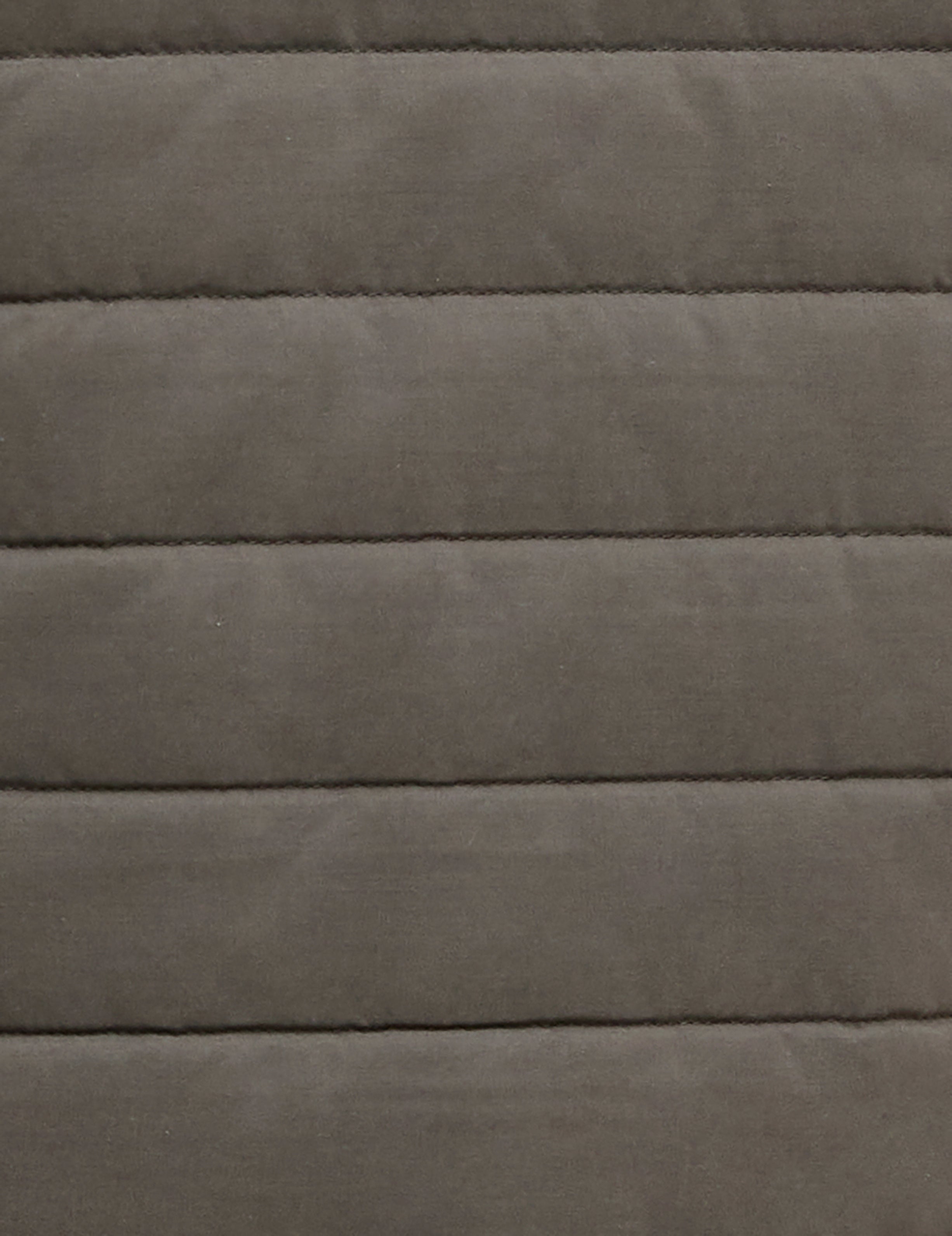 A close-up of a quilted fabric texture in a muted taupe-gray color, showing horizontal stitching and a soft, padded surface.