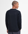 Man wearing a navy sweatshirt on a light gray background