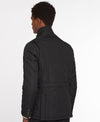 A man shown from the back wearing a black quilted jacket with a high stand-up collar, photographed against a clean white studio background.