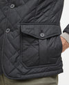 Quilted jacket with diamond pattern and Barbour brand logo on the pocket flap, on a neutral background