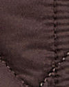 Close-up of a dark brown quilted fabric with visible stitching details.