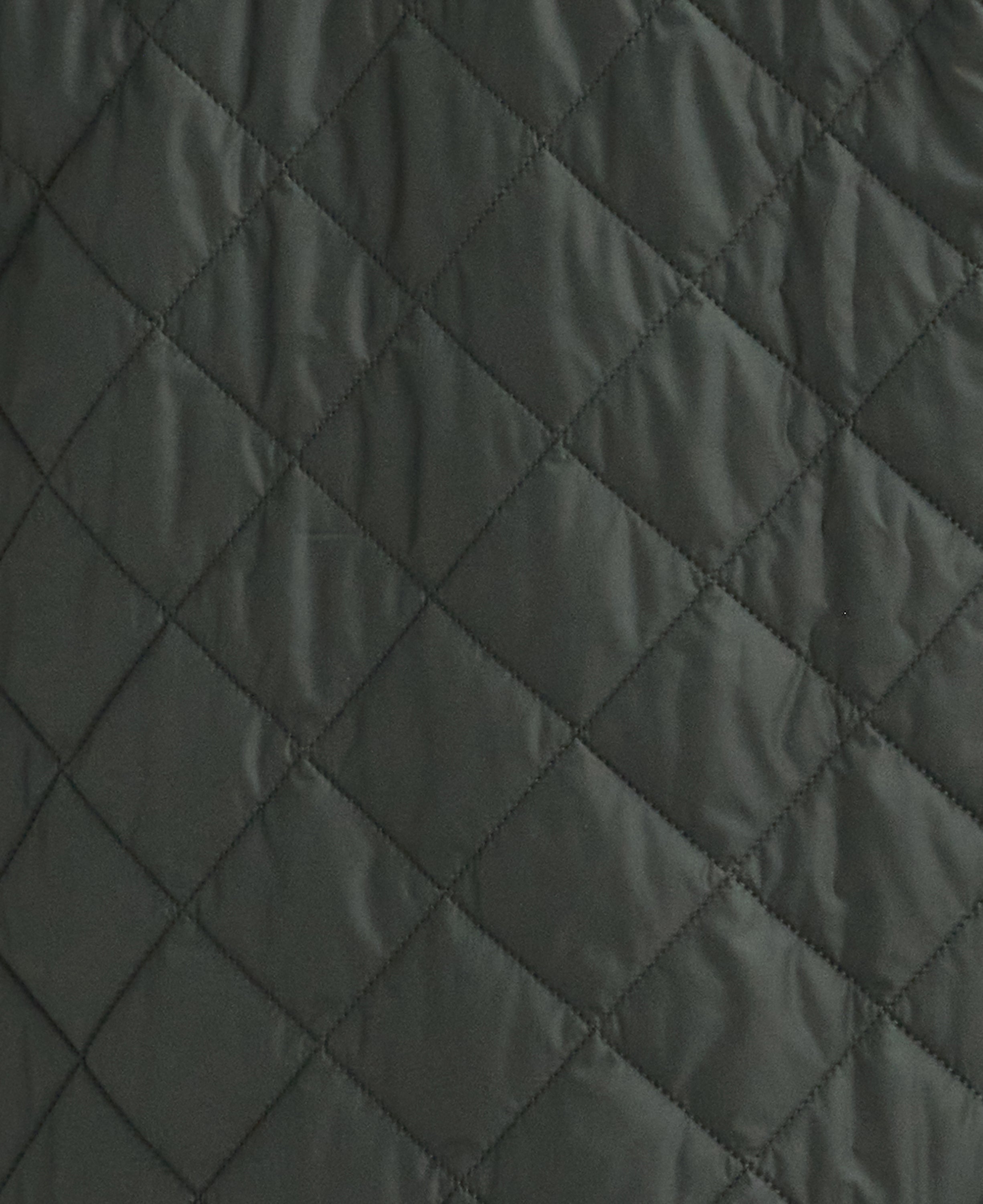 Close-up of a dark gray quilted fabric with a diamond stitching pattern.