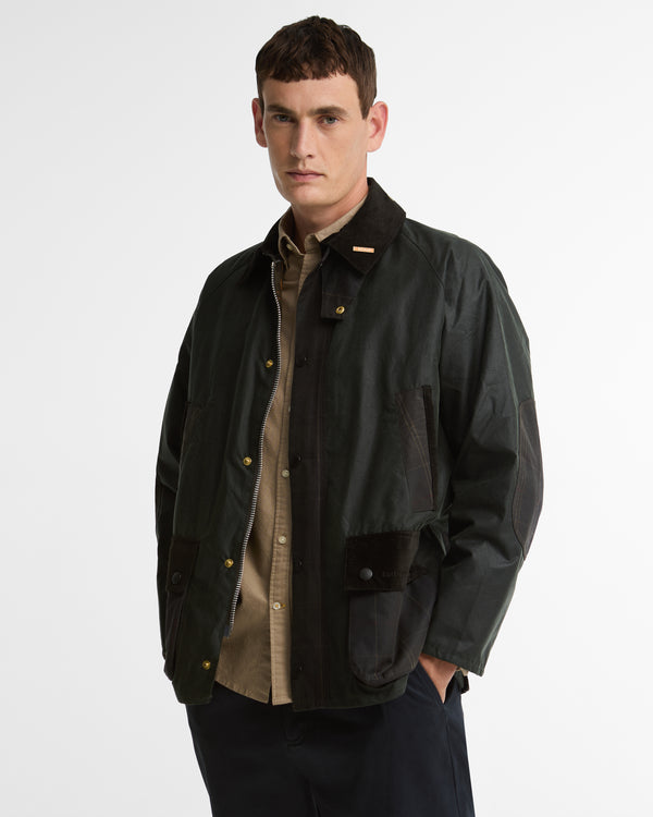 Model wearing the Barbour Icons Patch Bedale Wax Jacket, open in the front, showing the corduroy collar with Bedale pin and a gold snap button.