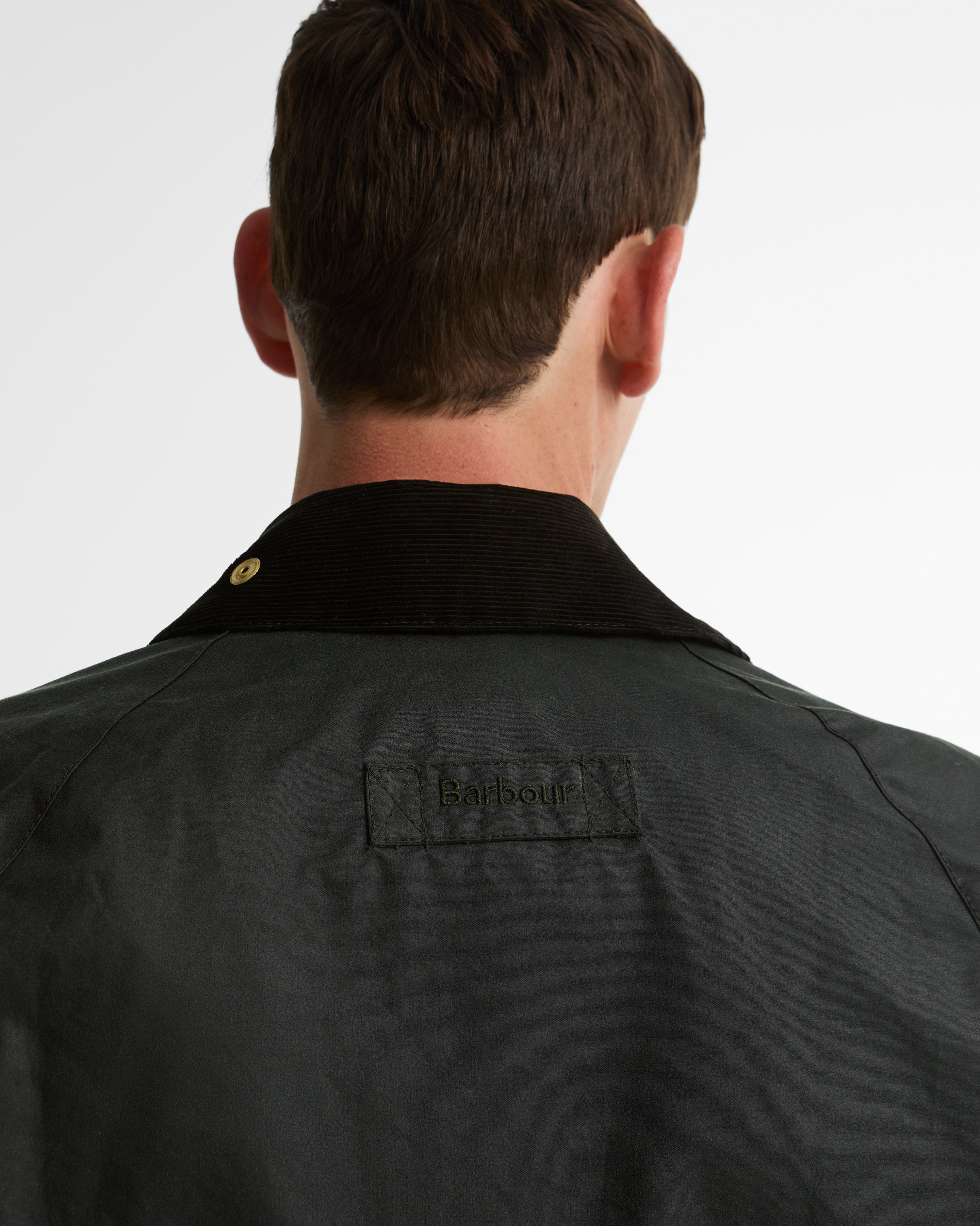 Rear close-up of the Barbour Icons Patch Bedale Wax Jacket showing the corduroy collar, gold snap, and embroidered Barbour patch on the back yoke.