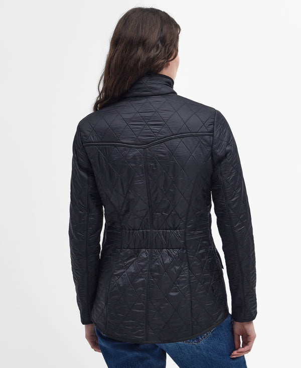 Person wearing a black quilted jacket on a white background