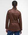 Person wearing a brown quilted jacket on a white background