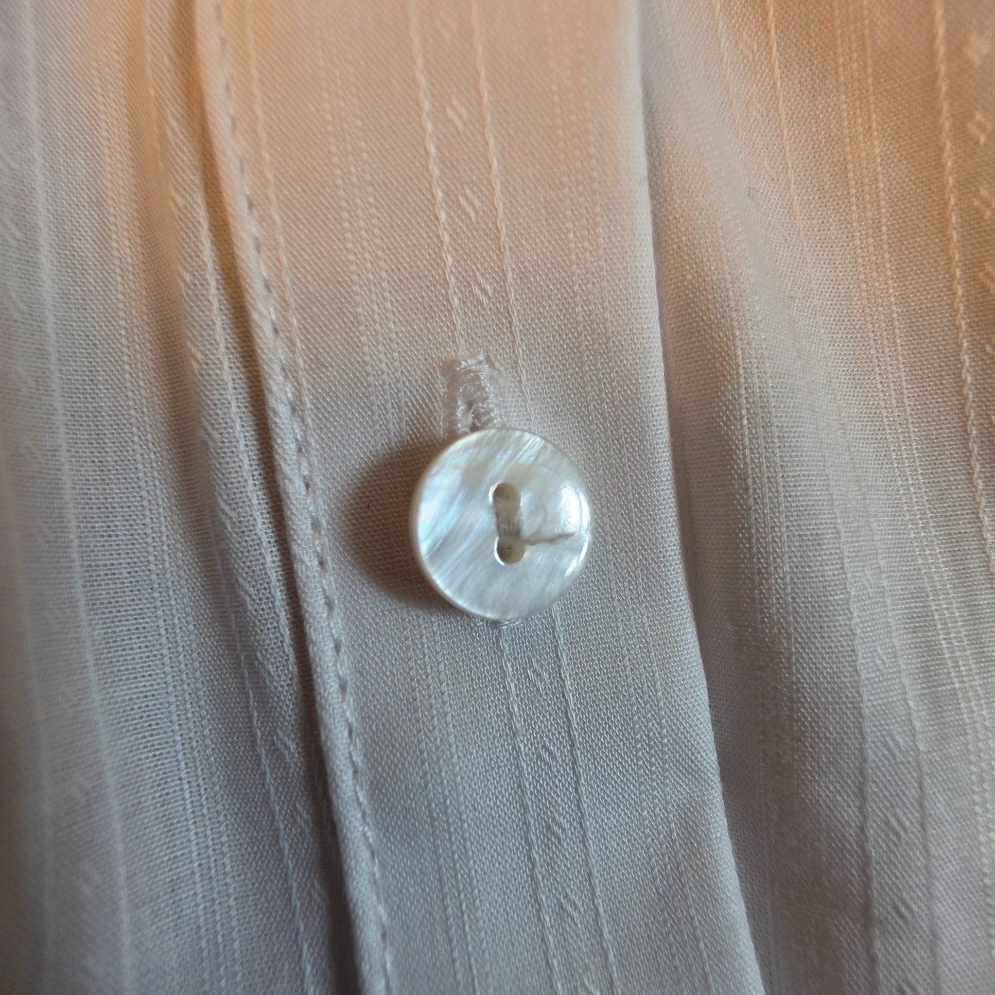 Close-up of Pearl White Stripe Bunny Show Shirt showing white-on-white striped fabric and pearlescent button