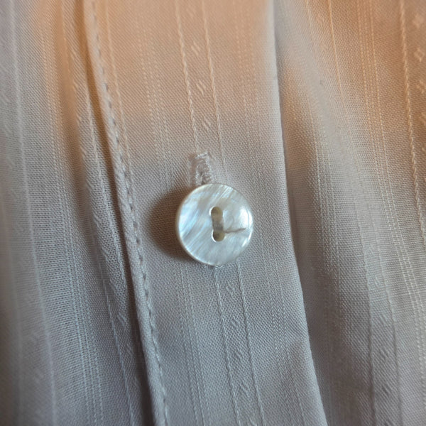 Close-up of Pearl White Stripe Bunny Show Shirt showing white-on-white striped fabric and pearlescent button