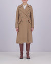 A video of a model wearing a mid-length, camel-colored, double-breasted wool coat with metallic buttons and tall brown boots, on a white background.